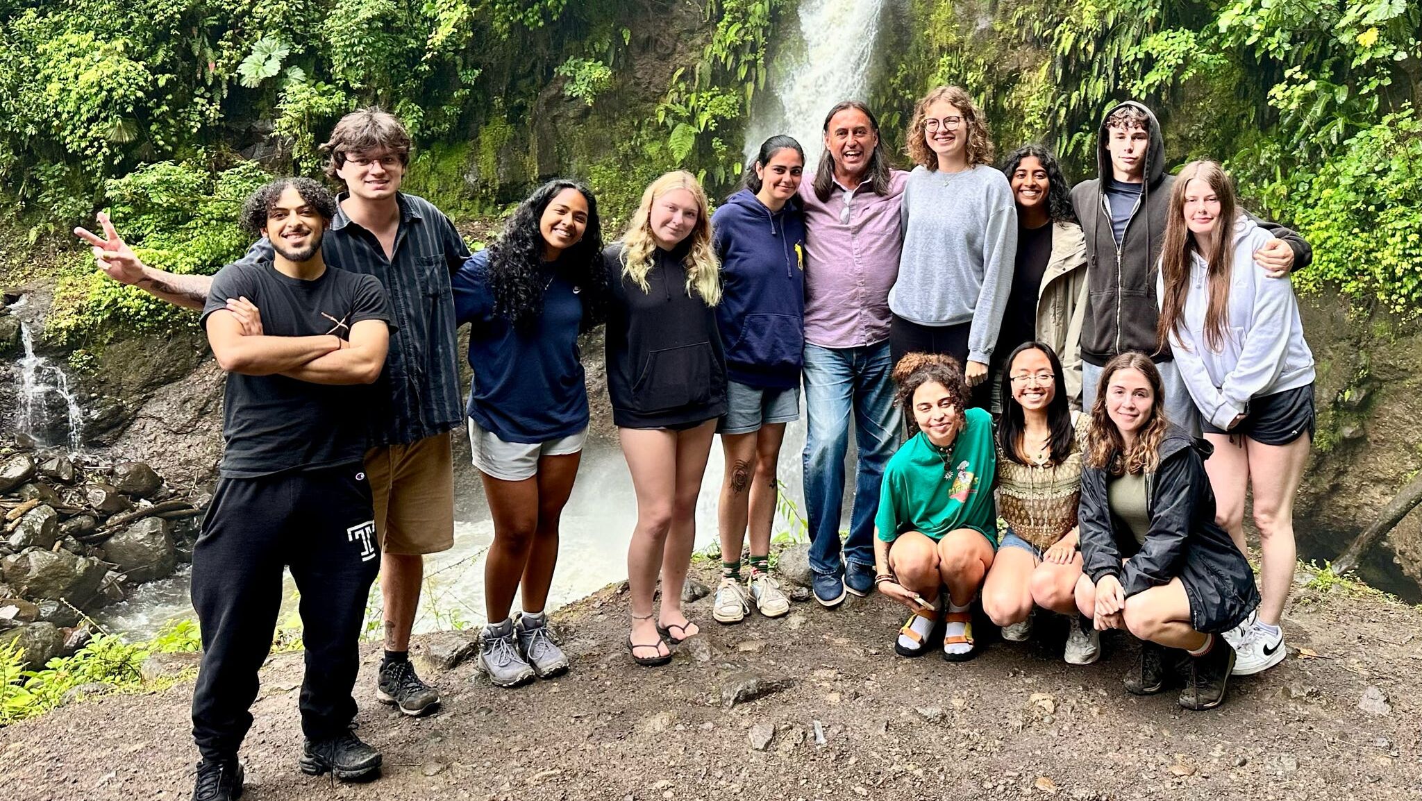 Dean Mostafa with students in Costa Rica, waterfall behind