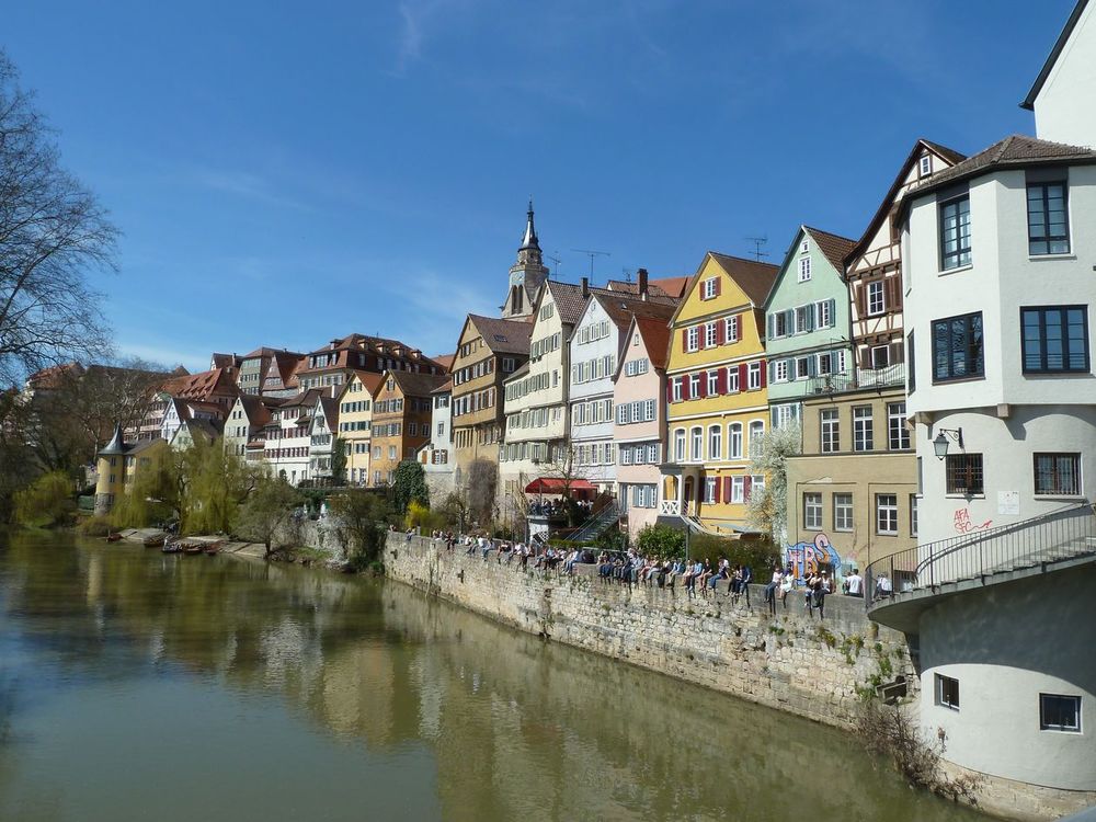 View of homes in Tubingen with reflection along the water. 