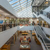 view of library interview with stairs on right and skylights, natural light bathing the space