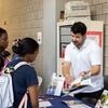 Rep showing students a study abroad brochure