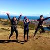 students jumping in front of landscape setting in the UK