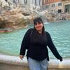 Photo of Mackenzie standing in front of the Trevi Fountain in Rome