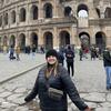 Photo of Megan standing in front of the Colosseum in Rome